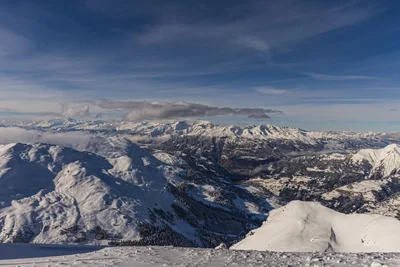 snow covered mountain range under dramatic sky