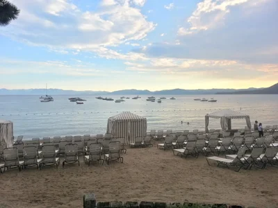 beach setup with lounge chairs facing calm waters