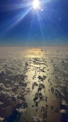 aerial view above clouds with sunlight streaming through
