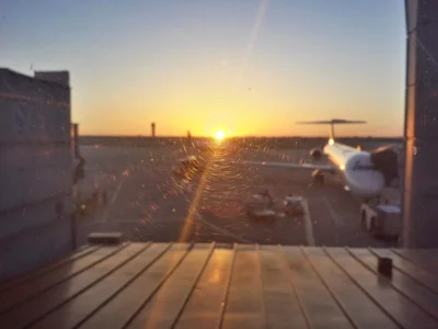 sunset view through wet glass at airport