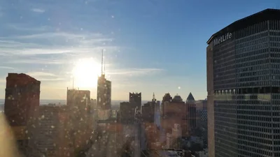 city skyline at sunset through window