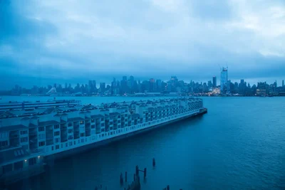 waterfront buildings extend into harbor at dusk
