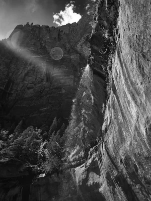 waterfall cascading down steep canyon walls