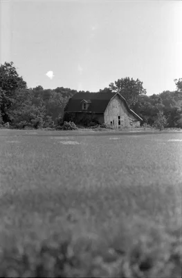 old barn in field with trees