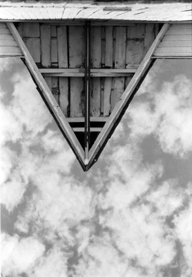 wooden structure viewed from below against cloudy sky