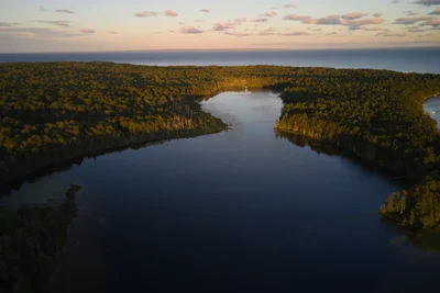 aerial view of forested lakes near coastline