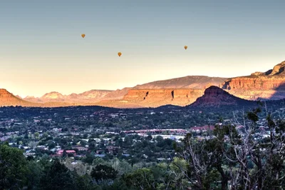 desert town with hot air balloons at sunset