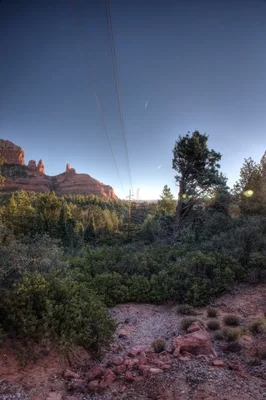 sedona red rocks with power lines at dusk