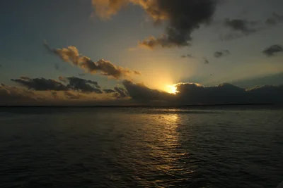 sunset over ocean with dramatic clouds