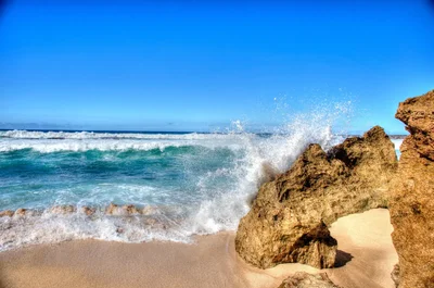 waves crashing against rocky beach shoreline