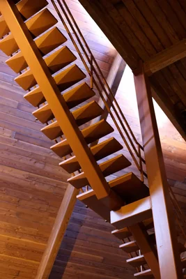 wooden staircase viewed from below looking upward
