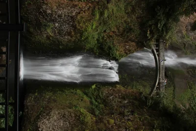 waterfall cascading down mossy cliff face