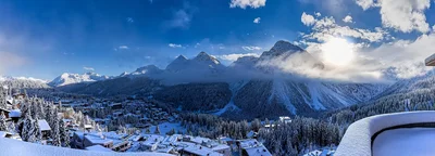 alpine ski resort village surrounded by snowy mountains