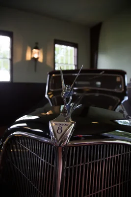 vintage hudson eight car hood ornament indoors