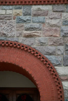 stone wall with red brick archway detail