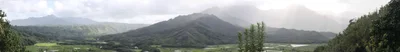 misty mountain valley with agricultural fields below