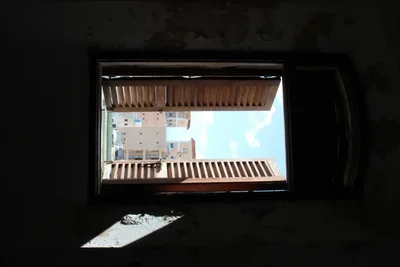 view through dark window showing buildings outside