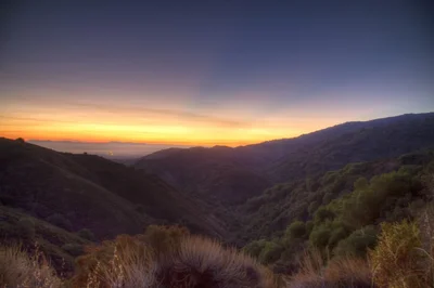mountain valley sunset with rolling hills