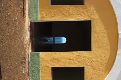 arched doorway in yellow stucco building