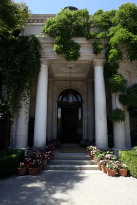 classical entrance with columns and potted flowers
