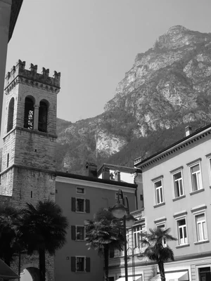 medieval tower with mountain backdrop and palm trees