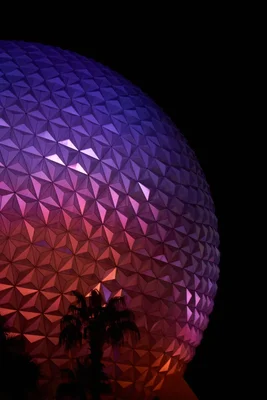 geodesic sphere illuminated purple pink at night