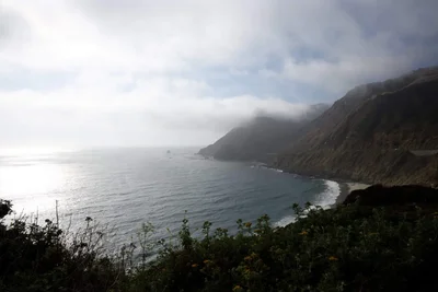 misty coastal cliffs meeting ocean waves