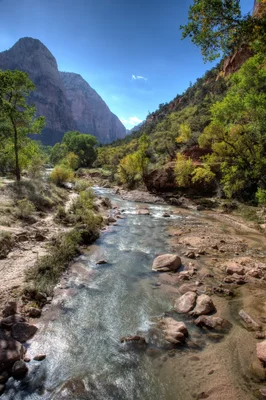 river flowing through canyon with towering cliffs
