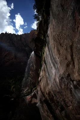 waterfall cascading down rocky canyon walls