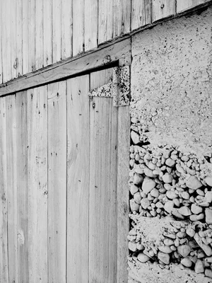 weathered wooden planks meet concrete and gravel