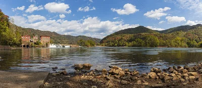 river valley with dam and autumn hills