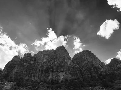rugged canyon walls beneath dramatic cloudy sky