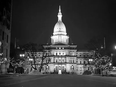 illuminated capitol building at night with decorative lights